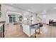 Open concept kitchen with island and view into living room at 4072 N Rome St, Aurora, CO 80019