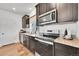 Kitchen features stainless steel appliances and dark wood cabinets at 4072 N Rome St, Aurora, CO 80019