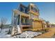 Two-story home with modern gray siding and snow at 4072 N Rome St, Aurora, CO 80019