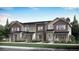 Modern townhome community with attached garages and landscaping at 1929 S Gold Bug Way, Aurora, CO 80018