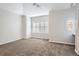 Large bedroom with neutral carpeting and window with shutters at 60 Garfield St # H, Denver, CO 80206