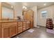 Clean bathroom with double vanity and wood cabinets at 6280 Indian Paintbrush St, Frederick, CO 80530