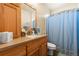 Bathroom with light wood vanity, single sink, and shower/tub combo at 6280 Indian Paintbrush St, Frederick, CO 80530