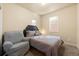Comfortable bedroom with a queen-size bed and gray armchair at 6280 Indian Paintbrush St, Frederick, CO 80530