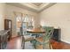 Charming dining area with round wooden table and four teal chairs at 6280 Indian Paintbrush St, Frederick, CO 80530