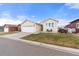 Tan two-car garage home with front yard and driveway at 6280 Indian Paintbrush St, Frederick, CO 80530