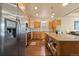 Bright kitchen with stainless steel refrigerator and light wood cabinets at 6280 Indian Paintbrush St, Frederick, CO 80530