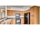 Well-equipped kitchen featuring granite countertops and black appliances at 10165 E Carolina Pl # 102, Aurora, CO 80247