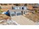 Two-story house with gray siding, two-car garage, and a landscaped yard at 4285 Mohawk Dr, Larkspur, CO 80118