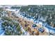 Community overview, showcasing houses nestled in a snow-dusted wooded area at 4285 Mohawk Dr, Larkspur, CO 80118