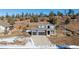 Two-story house with gray siding, two-car garage, and a landscaped yard at 4285 Mohawk Dr, Larkspur, CO 80118