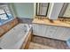 Spa-like bathroom featuring a deep soaking tub and double vanity at 4285 Mohawk Dr, Larkspur, CO 80118