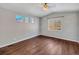 Bright bedroom with hardwood floors and large windows offering natural light at 4285 Mohawk Dr, Larkspur, CO 80118