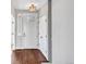Inviting entryway with hardwood floors, white door, and built-in storage at 4285 Mohawk Dr, Larkspur, CO 80118