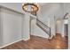 Bright entryway with hardwood floors, staircase, and large chandelier at 4285 Mohawk Dr, Larkspur, CO 80118