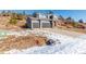 Two-story house with gray siding, two-car garage, and a landscaped yard at 4285 Mohawk Dr, Larkspur, CO 80118