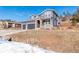 Two-story house with gray siding, two-car garage, and a landscaped yard at 4285 Mohawk Dr, Larkspur, CO 80118