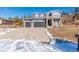 Two-story house with gray siding, two-car garage, and a landscaped yard at 4285 Mohawk Dr, Larkspur, CO 80118