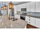 Modern kitchen with granite countertops and stainless steel appliances at 4285 Mohawk Dr, Larkspur, CO 80118