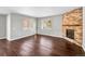 Spacious living room with hardwood floors and stone fireplace at 4285 Mohawk Dr, Larkspur, CO 80118