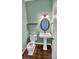 Powder room with pedestal sink, toilet, and a framed mirror at 4285 Mohawk Dr, Larkspur, CO 80118