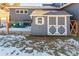 Gray shed with white trim in backyard, offering extra storage space at 4285 Mohawk Dr, Larkspur, CO 80118