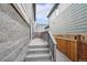 Steps leading to a private backyard patio, enclosed by a gray railing and wooden fence at 6192 N Lisbon St, Aurora, CO 80019