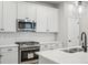 Modern kitchen with stainless steel appliances and white subway tile backsplash at 6192 N Lisbon St, Aurora, CO 80019