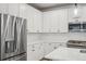Modern kitchen with stainless steel appliances and white cabinetry at 6192 N Lisbon St, Aurora, CO 80019