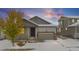 House exterior view, two-car garage, snowy yard at 18129 E 99Th Pl, Commerce City, CO 80022