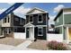 Two-story home with dark-green exterior, white trim, and landscaping at , Commerce City, CO 80022