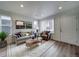 Bright living room with hardwood floors, comfy seating, and large windows at , Commerce City, CO 80022