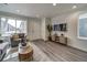 Living room featuring hardwood floors, a modern TV stand, and ample natural light at , Commerce City, CO 80022