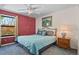 Bright bedroom with a queen-size bed and a large window at 1678 S Rosemary St, Denver, CO 80231