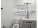 Bathroom with gray vanity, toilet and mirror at 8701 Huron St # 10-210, Thornton, CO 80260