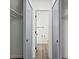 View down hallway to clean bathroom with gray vanity at 8701 Huron St # 10-210, Thornton, CO 80260