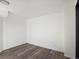 Simple bedroom with wood-look flooring and neutral walls at 8701 Huron St # 10-210, Thornton, CO 80260