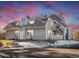 Gray multi-unit building with parking and landscaping at 8701 Huron St # 10-210, Thornton, CO 80260