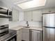 Modern kitchen with stainless steel appliances at 8701 Huron St # 10-210, Thornton, CO 80260
