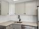Modern kitchen with gray cabinets at 8701 Huron St # 10-210, Thornton, CO 80260