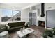 Living room with fireplace and green sofas at 8701 Huron St # 10-210, Thornton, CO 80260