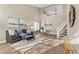 Bright living room with hardwood floors, high ceilings, and a staircase at 4423 S Kalispell Cir, Aurora, CO 80015