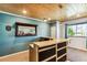 Basement bar with wood top and dark cabinets at 7095 S Titus St, Aurora, CO 80016