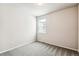 Bright bedroom with grey carpet and a window at 7095 S Titus St, Aurora, CO 80016