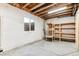 Unfinished basement with shelving and ample storage space at 7095 S Titus St, Aurora, CO 80016