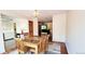 Bright dining area with wood table and chairs, access to living room and kitchen at 7623 S Cove Cir, Centennial, CO 80122