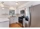 Kitchen with stainless steel appliances and white cabinets at 16812 E Mansfield Cir, Aurora, CO 80013