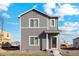 Two-story gray house with white trim and a front walkway at 2973 Oxley St, Strasburg, CO 80136