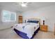 Bright bedroom with ceiling fan, wood furniture, and window at 1618 S Kenton St, Aurora, CO 80012