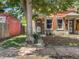 Front view of a brick duplex with mature trees at 317 Delaware St, Denver, CO 80223